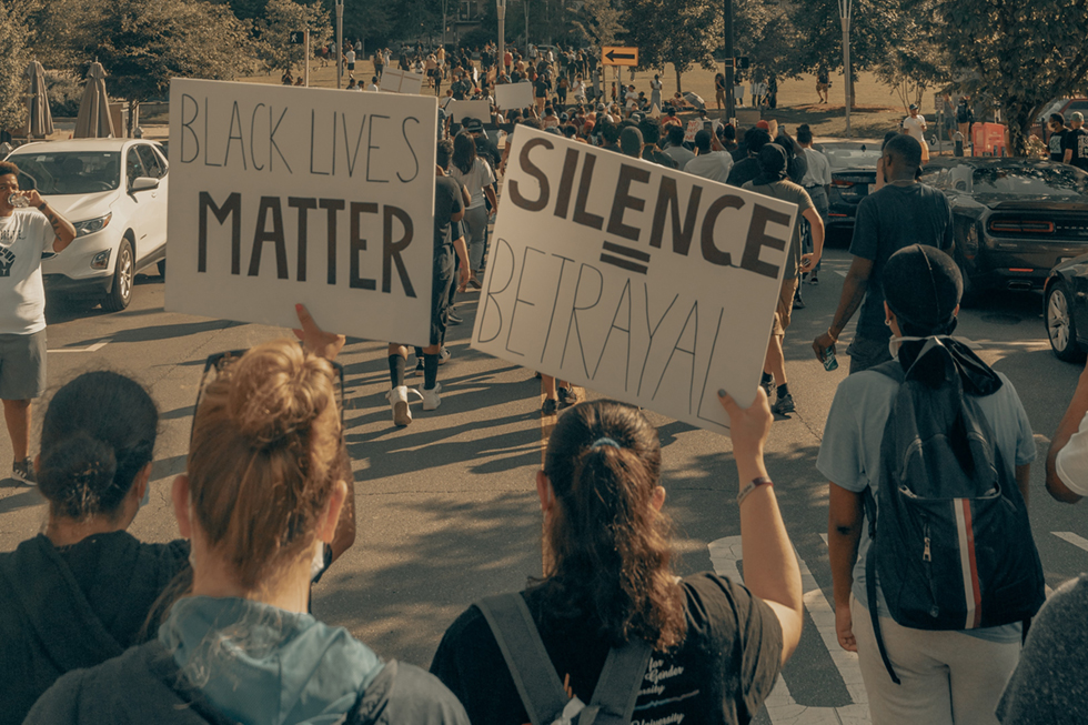 people holding signs at protest