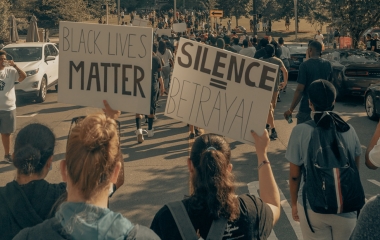 people holding signs at protest